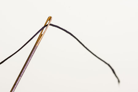 Needle and thread isolated on white