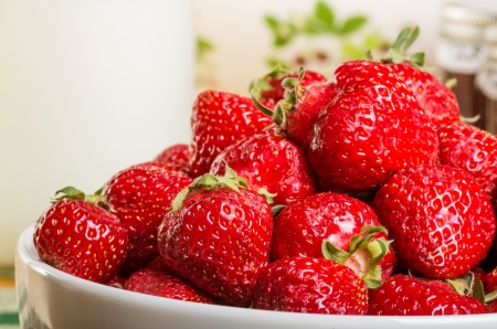 Bowl of fresh ripe strawberries on a tableの写真素材