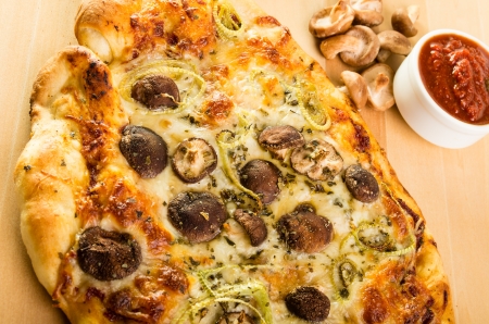 An artisan pizza with shitake mushrooms fennel and mozzarella cheeseの写真素材