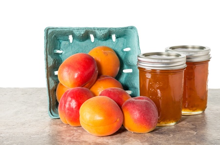 Fresh apricots preserved as homemade jam and in mason jarsの写真素材