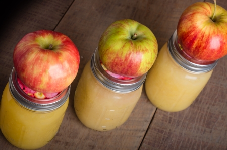 Jars of canned applesauce with fresh applesの写真素材