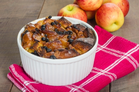 Apple bread pudding with raisins baked in white bowlの写真素材