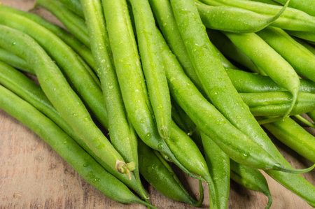 Fresh green beans or snap beans on a wooden table