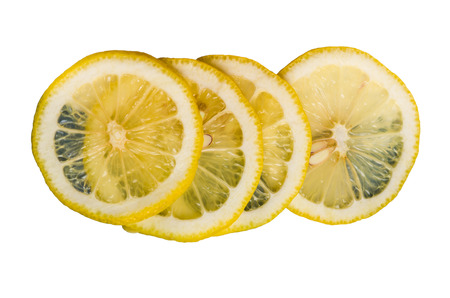 Lemon slices stacked and isolated on whiteの写真素材