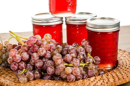 Jars of fresh pink grape jelly with grapesの写真素材