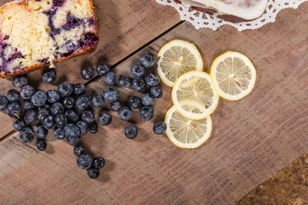 Blueberry coffee cake roll with slices of lemons and blueberriesの写真素材