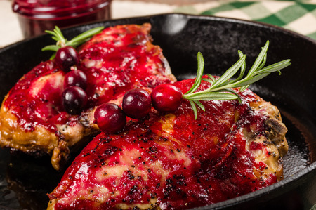 Skillet of cast iron with two glazed chicken breastsの写真素材