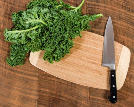 Green curly kale and chef knifeの写真素材