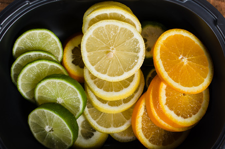 Bowl with lemon, lime and orange slicesの写真素材