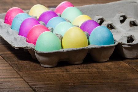 Paper egg carton of colorful naturally dyed Easter eggs