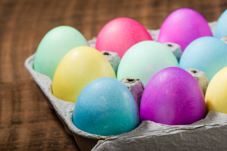Paper egg carton of colorful naturally dyed Easter eggs