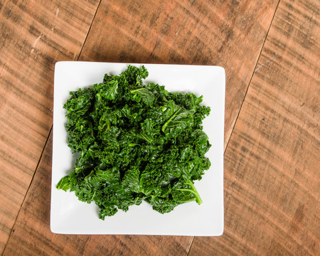 Kale greens on white plate ready to serveの写真素材