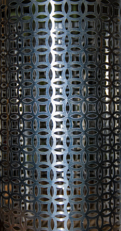 Metal screen made from patterned punched metalの写真素材