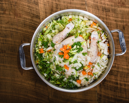 Ingredients for chicken soup in a cook pot ready for cookingの写真素材