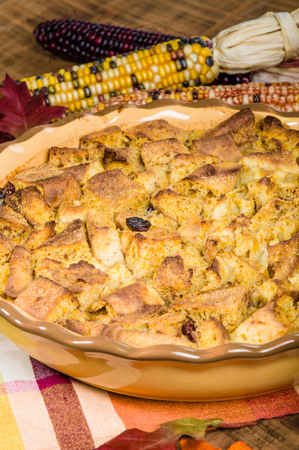 A bread pudding with raisins desert with fall or Thanksgiving decorationsの写真素材
