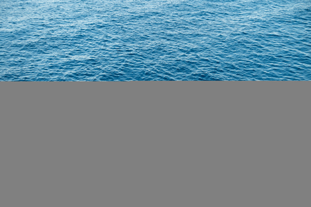 Water background with blue peaceful ripples for use as texture or backgroundの写真素材