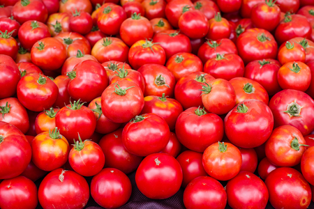 Display of fresh red ripe tomatoes at the farmers marketの写真素材