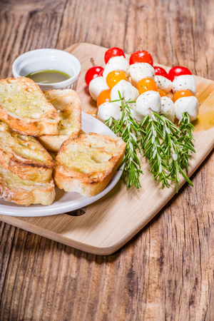 Tomato cheese and bread appetizers on rosemary skewersの写真素材