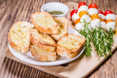 Tomato cheese and bread appetizers on rosemary skewersの写真素材