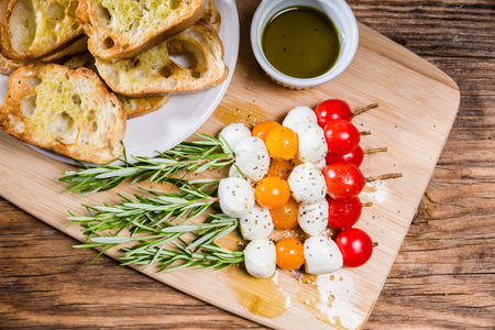 Tomato cheese and bread appetizers on rosemary skewersの写真素材