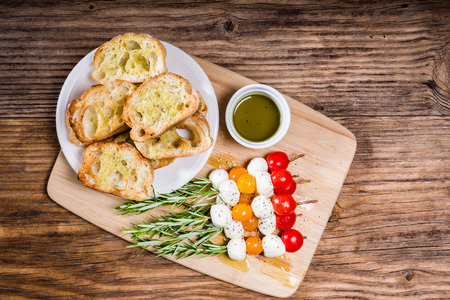 Tomato cheese and bread appetizers on rosemary skewersの写真素材