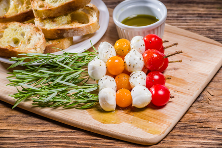 Tomato cheese and bread appetizers on rosemary skewersの写真素材