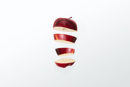 Red apple sliced in half on a white background. Isolated.の写真素材