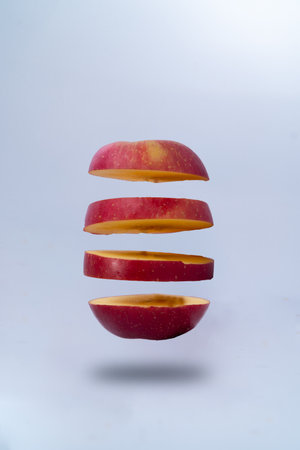 red apple flying in the air on a white background. studio shotの素材