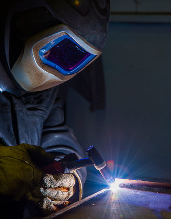 welder, craftsman, erecting technical steel Industrial steel welder in factory