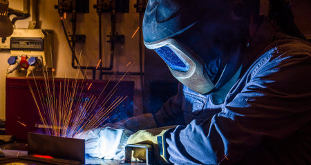 welder, craftsman, erecting technical steel Industrial steel welder in factory