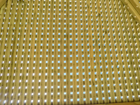 Modern design pergola arbor made wood with clear blue summer sky background roof wooden arborの写真素材