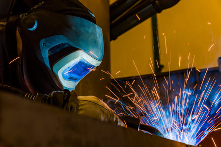 welder, craftsman, erecting technical steel Industrial steel welder in factory