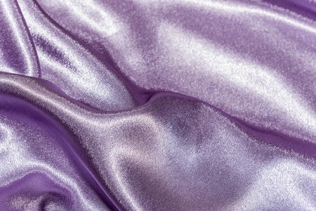 Beautiful smooth elegant wavy violet purple satin silk luxury cloth fabric texture, abstract background design. Card or banner. sewing material abstractionの写真素材