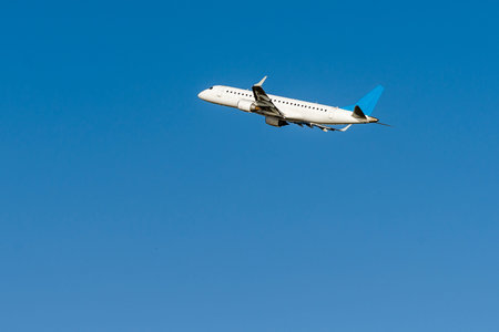 A huge commercial air plane just departure and flying on the blue sky. plane taking off into the sky
