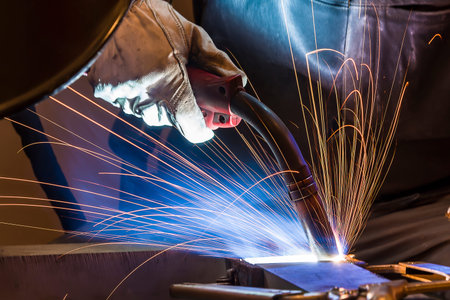 welder, craftsman, erecting technical steel Industrial steel welder in factory