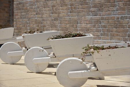 Wooden Wheelbarrow with flowers wooden Wheelbarrows for a gardenの写真素材