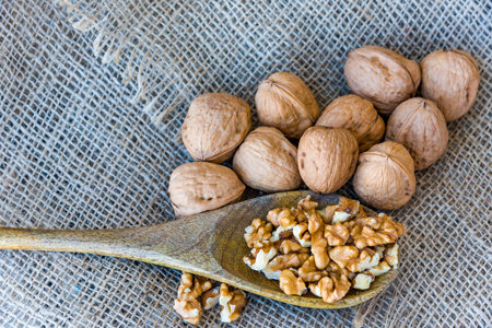 On burlap, peeled walnuts peeled on a wooden