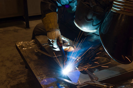 welder, craftsman, erecting technical steel Industrial steel welder in factory