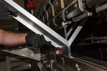 operator bending metal sheet by sheet bending machine bending of metalの写真素材