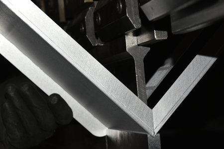 operator bending metal sheet by sheet bending machine bending of metal