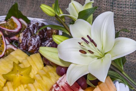 Healthy fresh fruits in a basket on table Sliced fruits in a basket kiwi pineapple strawberry.の写真素材