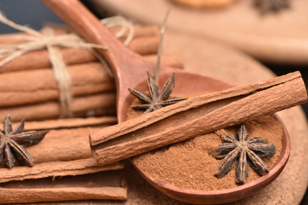 Cinnamon sticks and meal close up on wooden table