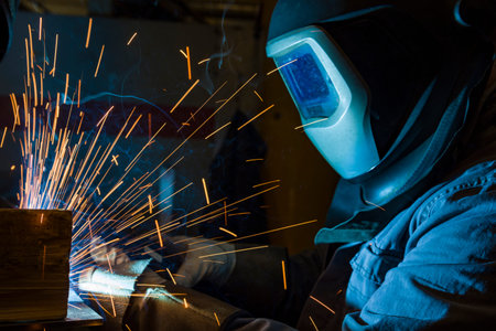 The welder is welding metal, erecting technical steel Industrial steel welder in factory technical,