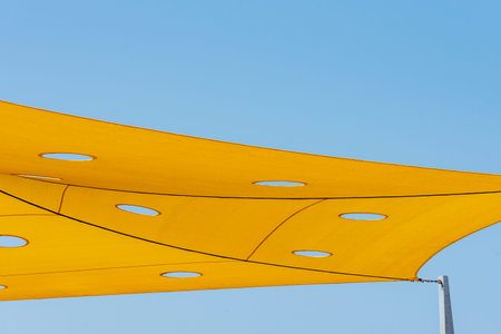 Fabrics to cover the sun and make shadows, with triangular shapes. stretched fabric sun protection