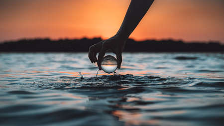 Lens ball sea sunset photoの写真素材