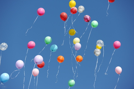 many balloons in a blue skyの写真素材