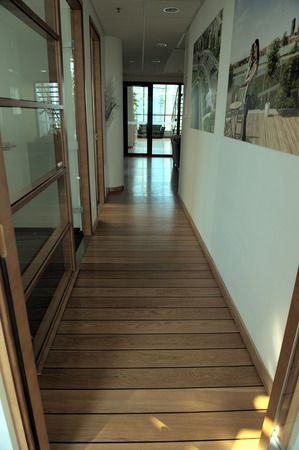 wooden office corridor going to light office roomの写真素材