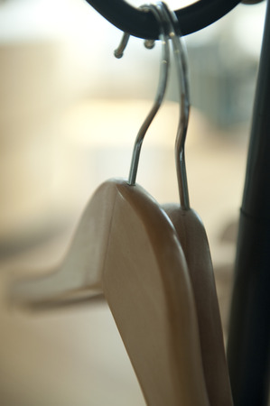 two wooden clothes-hangers on the hallstandの写真素材