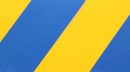 Yellow and Blue diagonal hazard stripesの写真素材