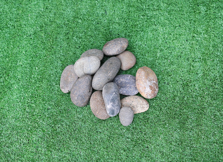 stones on grass , round stones on grass background